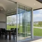 Modern sliding glass doors open to outdoor patio and garden.